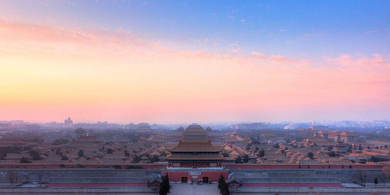 Aerial view of the Forbidden City showing golden-roofed halls and red walls along the central axis
