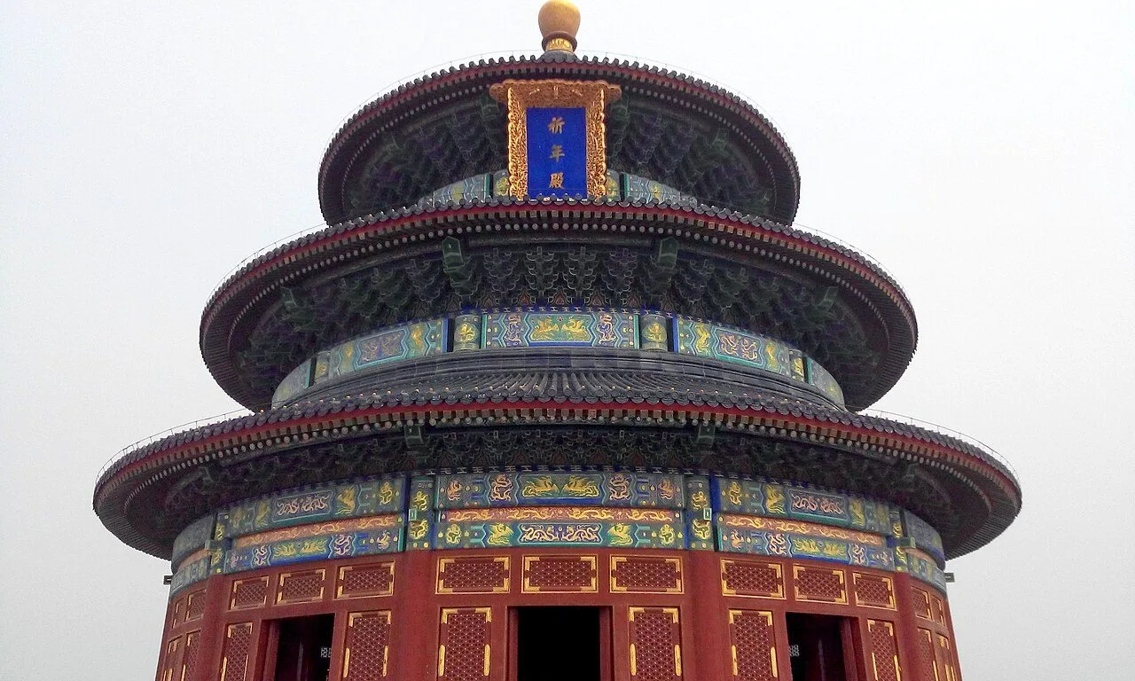 The Hall of Prayer for Good Harvests, a triple-eaved circular building in deep blue tiles, photographed from below against a winter sky