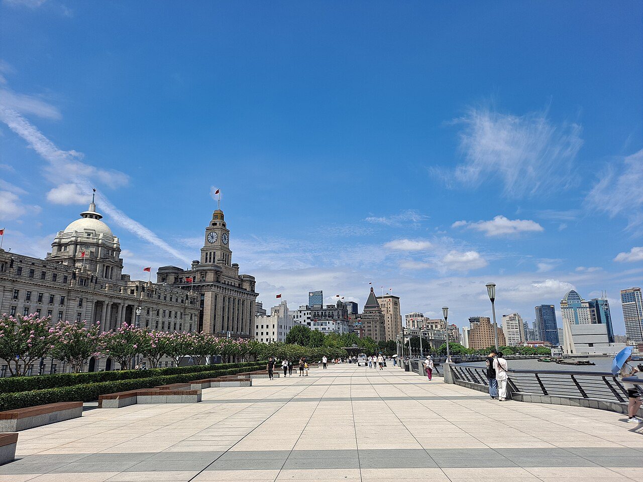 The Bund at night, with the colonial-era buildings lit up in golden light and the Lujiazui skyline across the Huangpu River