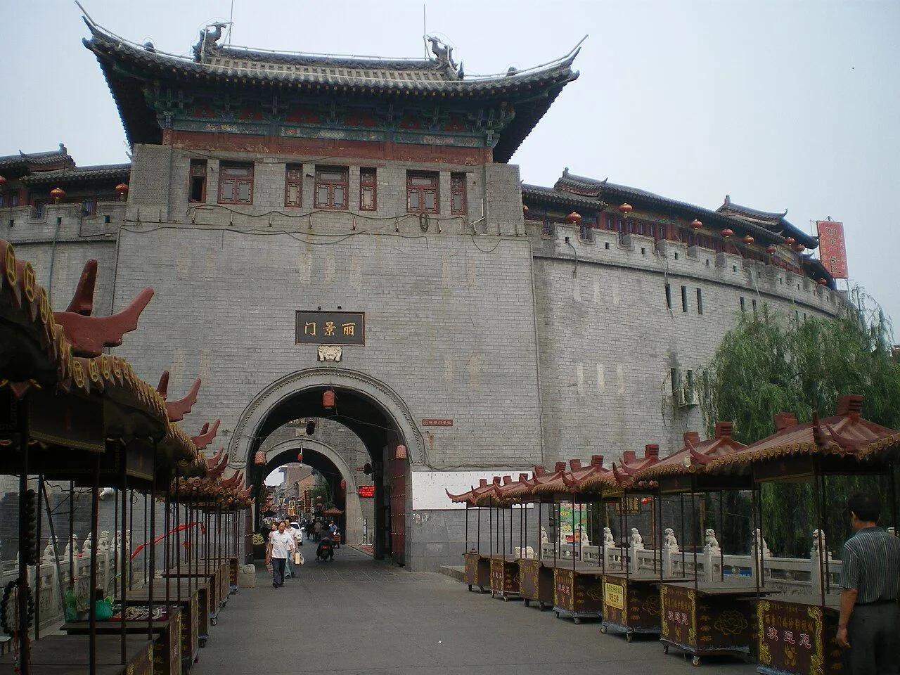 The Lijing Gate (丽景门) of Luoyang Old Town — the iconic three-tiered gate tower with traditional curved eaves, the main entrance to the 1,200-year-old food street at the heart of Luoyang’s historic district that draws over 10 million visitors a year