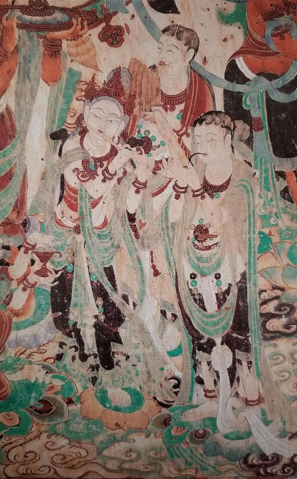 Dunhuang mural from Cave 159 — a Tang-dynasty painting of Buddhist flying musicians (apsaras) and bodhisattvas with celestial instruments, in the classic silk-road iconographic style
