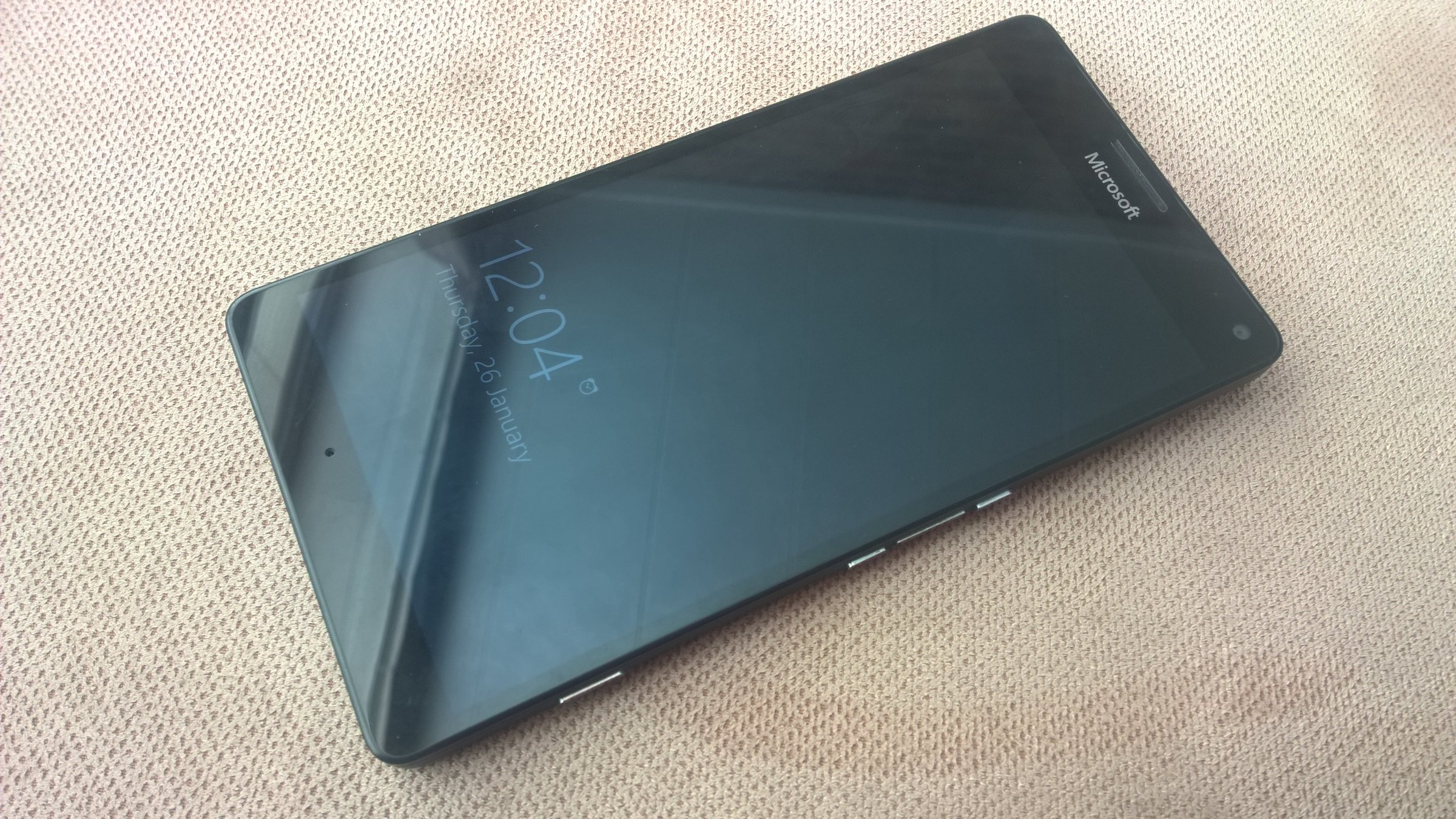A modern smartphone with dual SIM card tray, showing the removable tray for two nano SIM cards