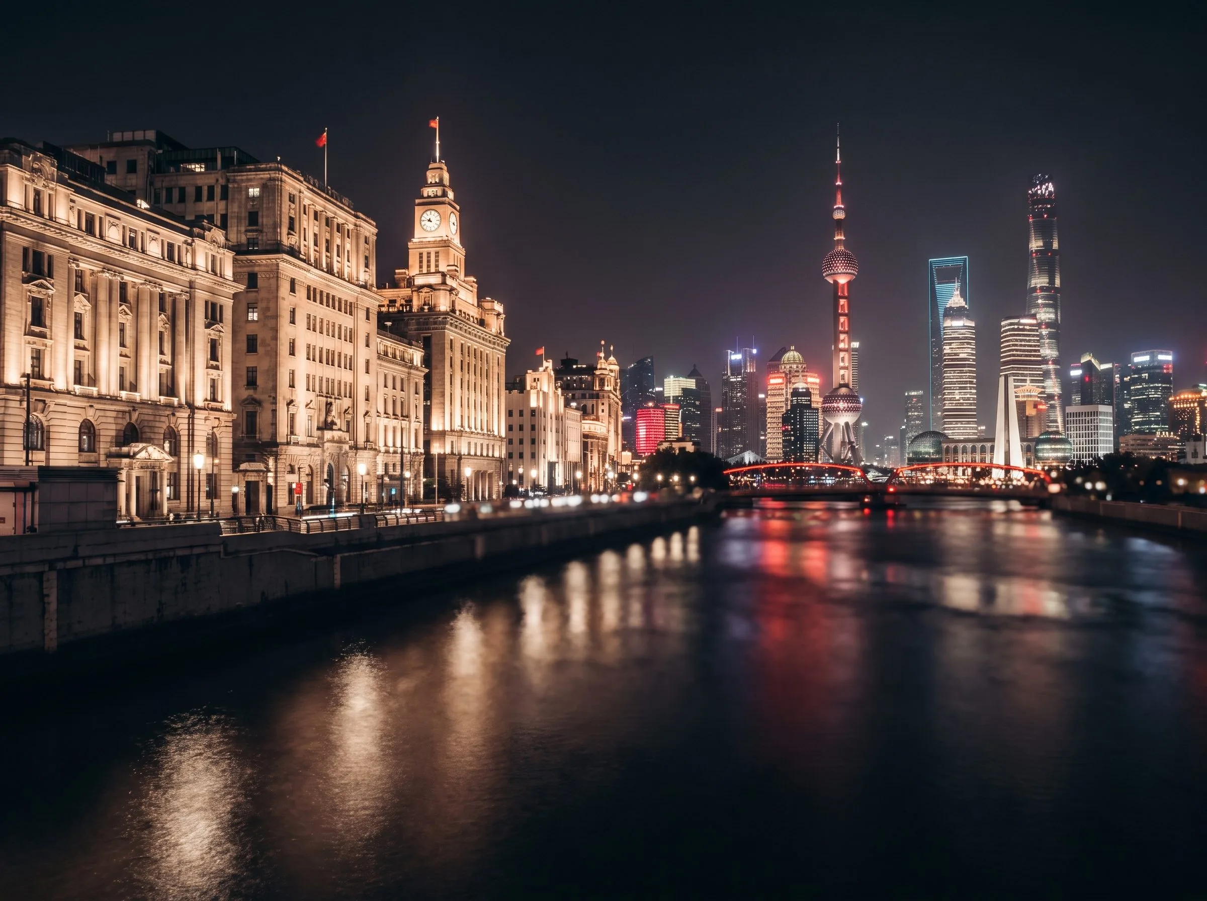 The Bund Shanghai at night, colonial European architecture facing ultramodern Pudong skyscrapers across the Huangpu River
