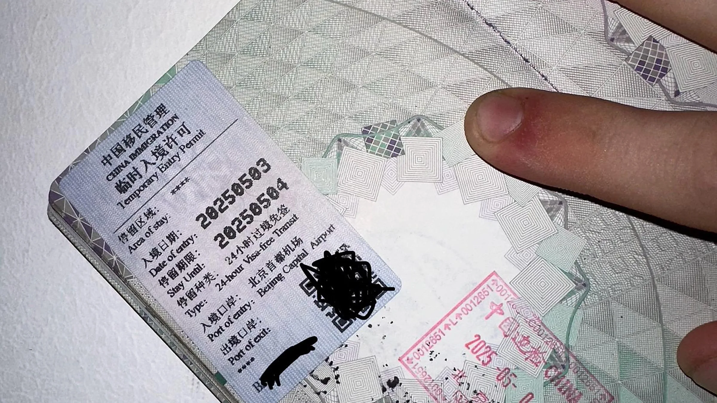 Real Chinese Temporary Entry Permit stapled into a Western passport — the small slip shows 24-hour Visa-free Transit, Beijing Capital Airport, with a red entry/exit stamp next to it