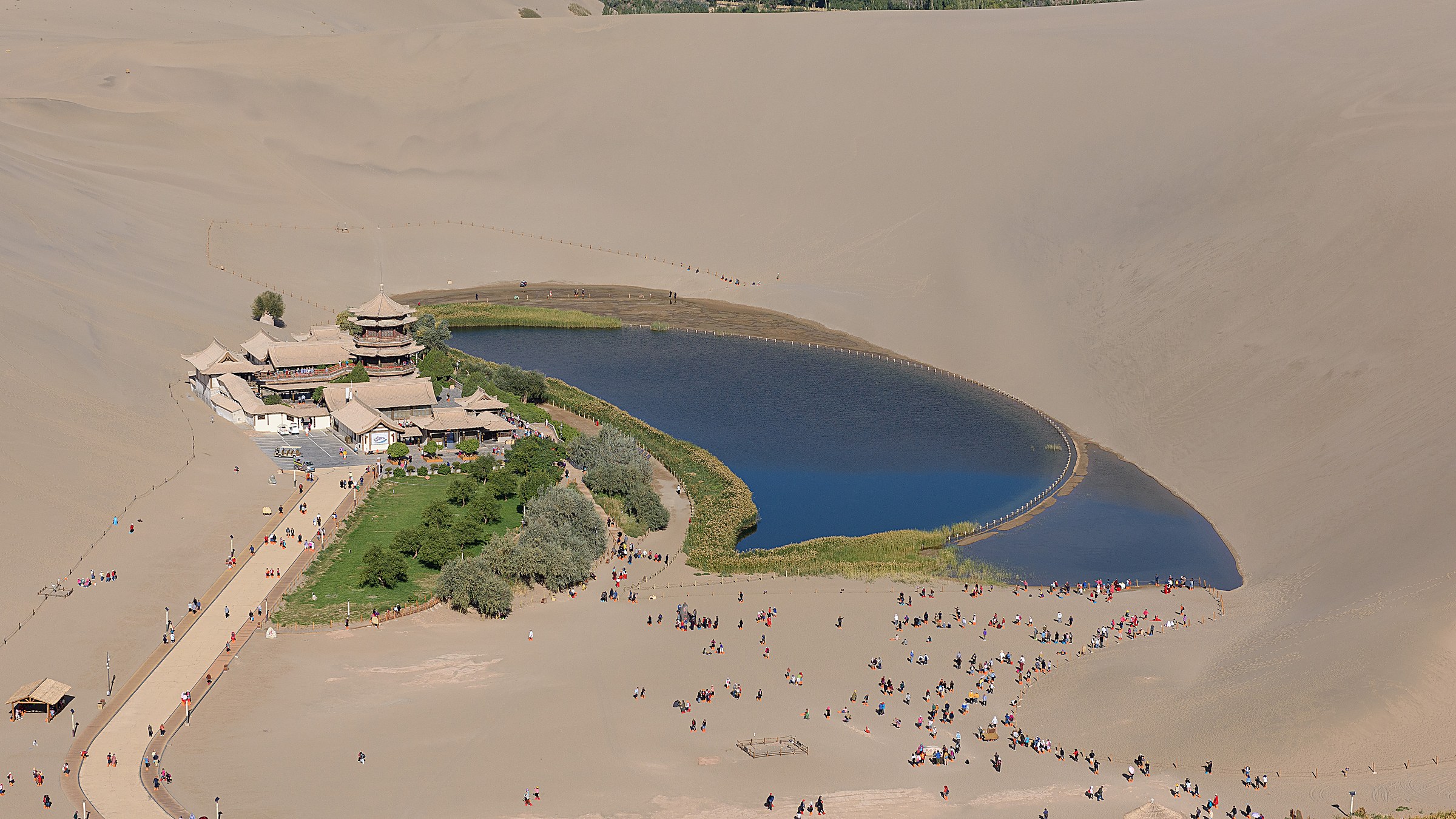 Mingsha Dunes + Crescent Lake (鸣沙山月牙泉) — a 1,500-year-old miracle: a crescent-shaped spring between sand dunes in the Gobi desert, where the singing sand dunes hum in the wind.