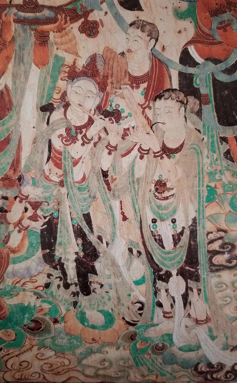 A Tang-dynasty mural reproduction of musicians (Cave 159) at the Mogao Caves in Dunhuang, depicting a procession of court musicians in flowing robes playing flutes and stringed instruments.