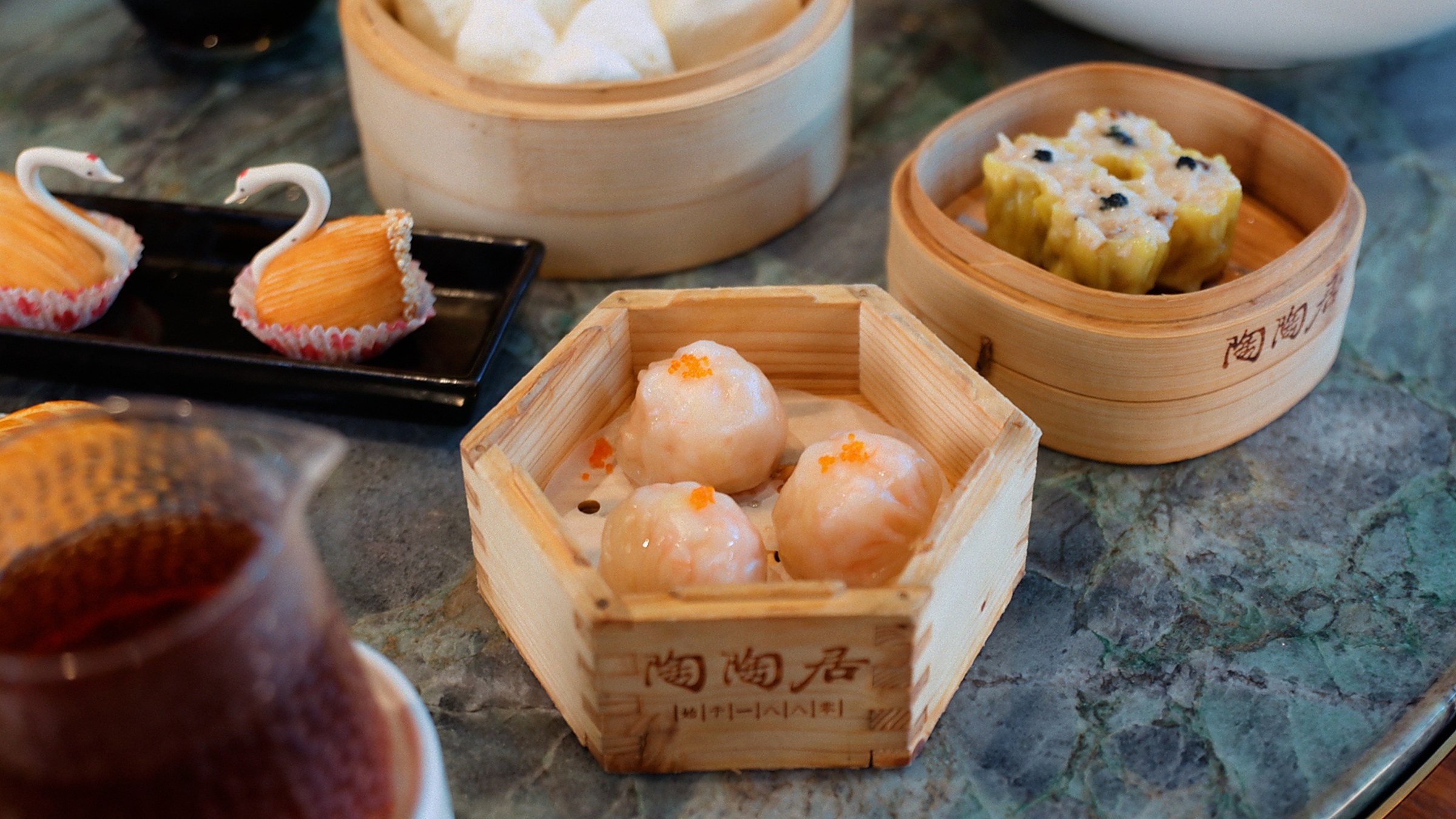 Cantonese dim sum at Tao Tao Ju — har gow, siu mai, and chasiu bao in bamboo steamers.