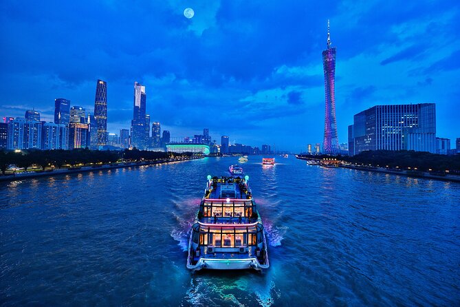 Pearl River night cruise — a small tourist boat in the foreground with the illuminated Canton Tower (purple and pink) and the Liede Bridge behind, the Guangzhou skyline lit at blue hour
