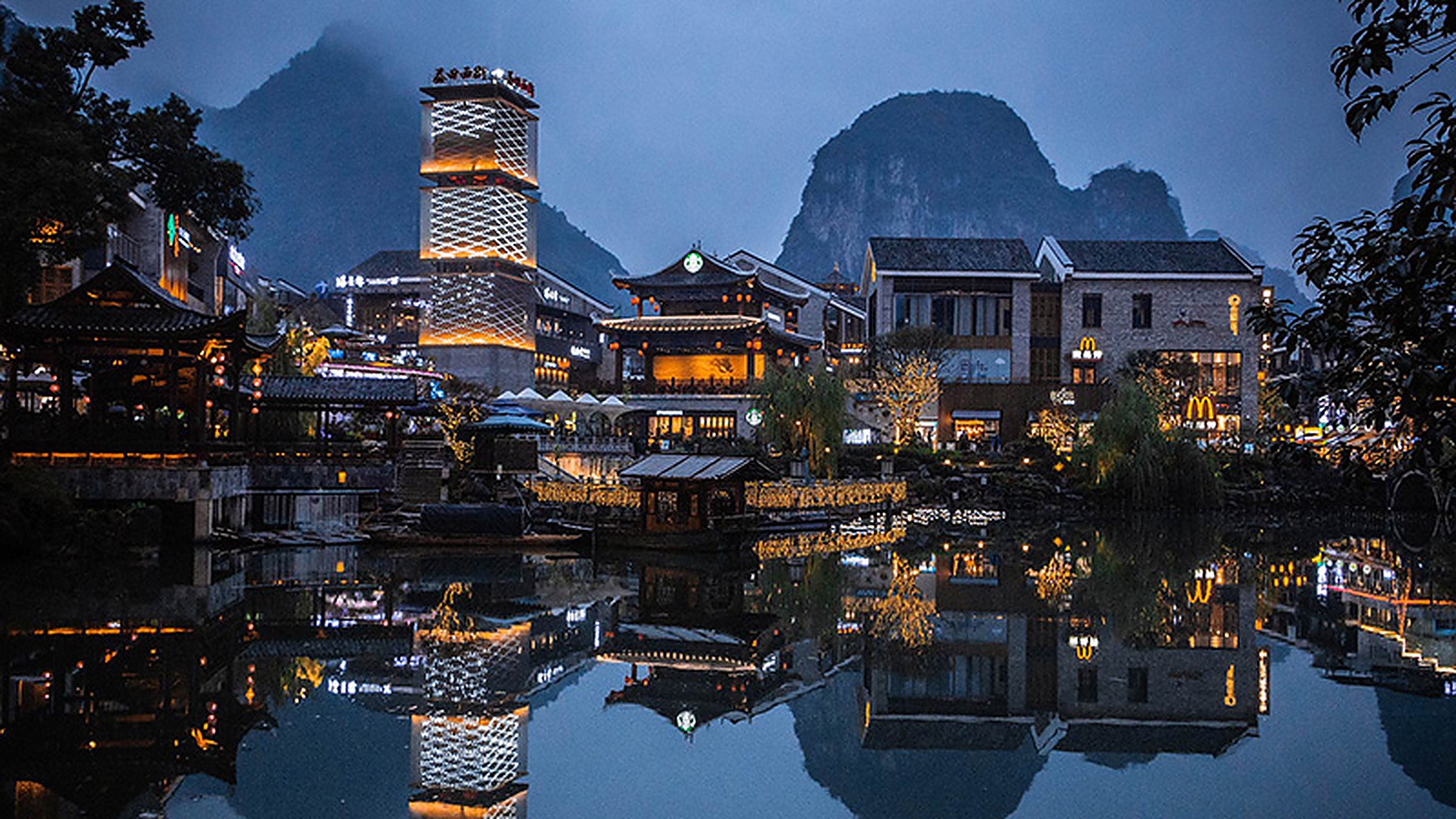 Yangshuo karst peaks reflected in the Li River at night