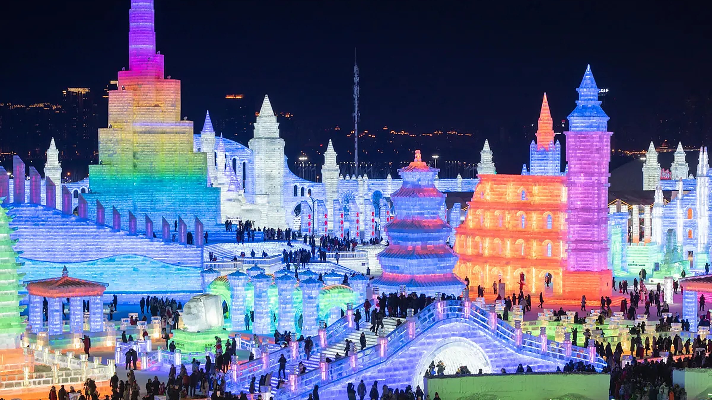 Harbin Ice and Snow World at night — illuminated ice buildings and an ice castle