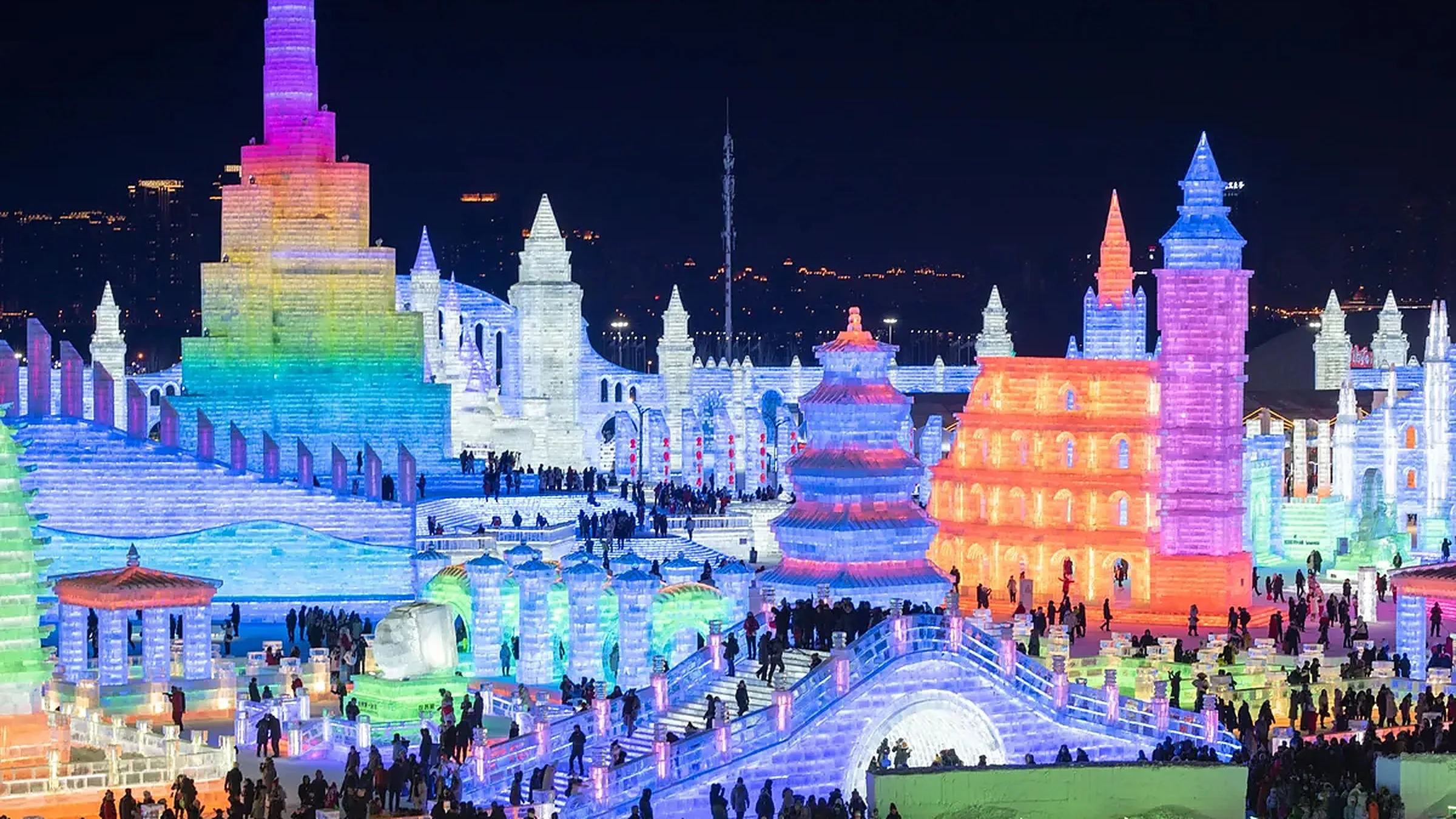 Harbin Ice and Snow World at night — illuminated ice buildings and an ice castle
