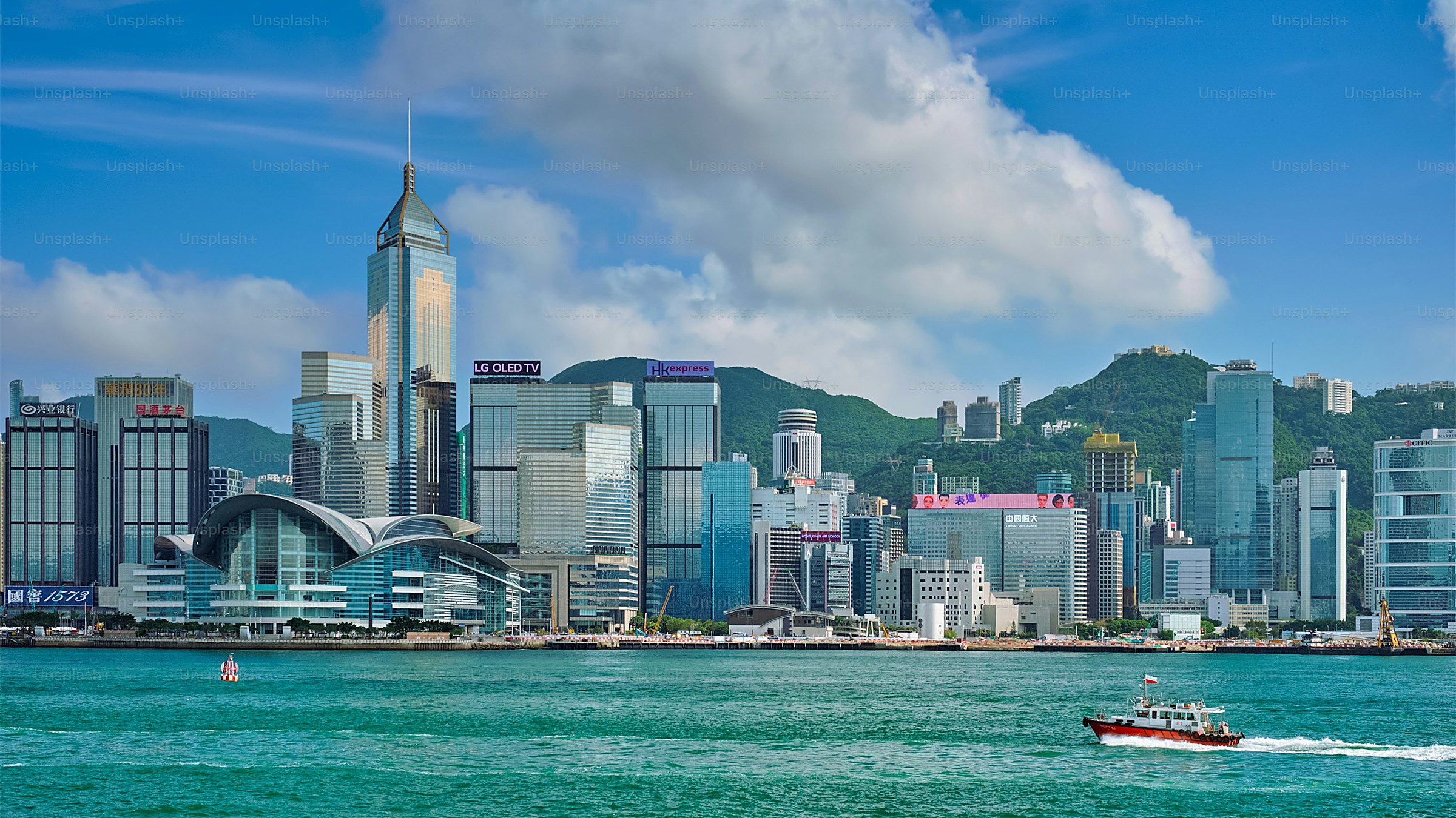 Tsim Sha Tsui — Kowloon's waterfront promenade across from Hong Kong Island's skyline, the Avenue of Stars, and the nightly Symphony of Lights.