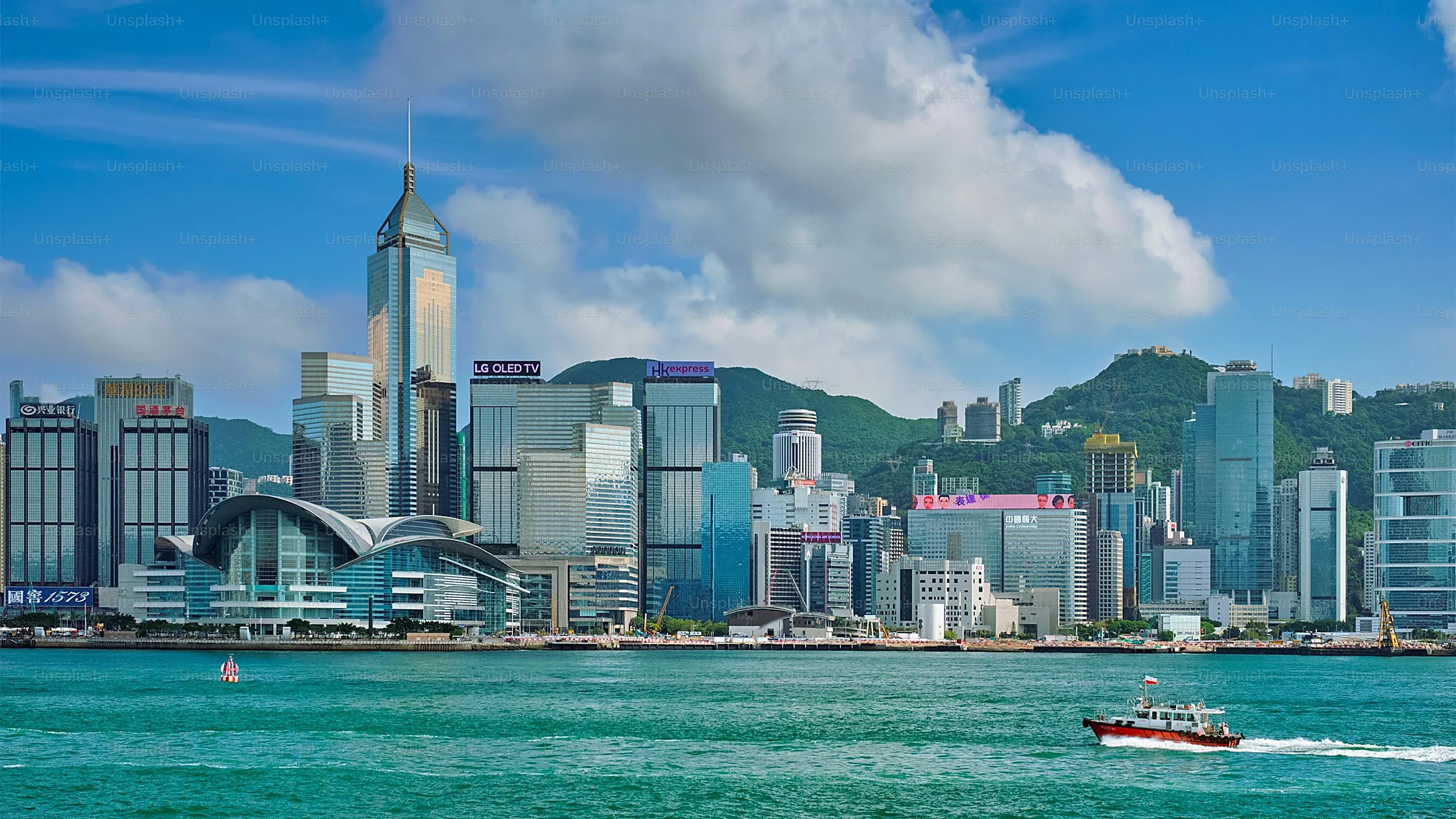 Tsim Sha Tsui — Kowloon's waterfront promenade across from Hong Kong Island's skyline, the Avenue of Stars, and the nightly Symphony of Lights.