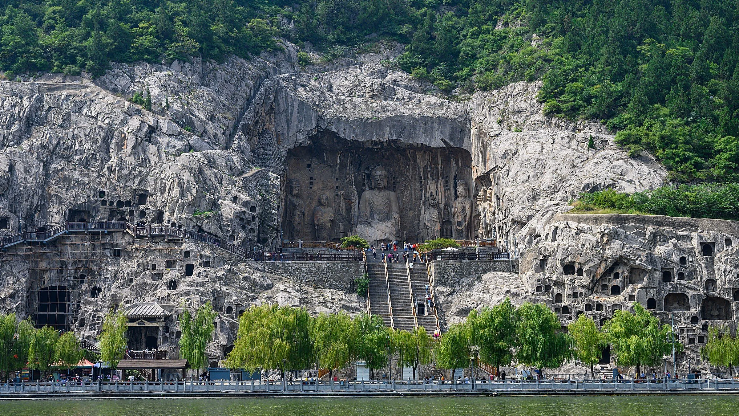 The 17-meter Vairocana Buddha at Fengxian Temple, Longmen Grottoes — the pinnacle of Tang dynasty Buddhist sculpture.