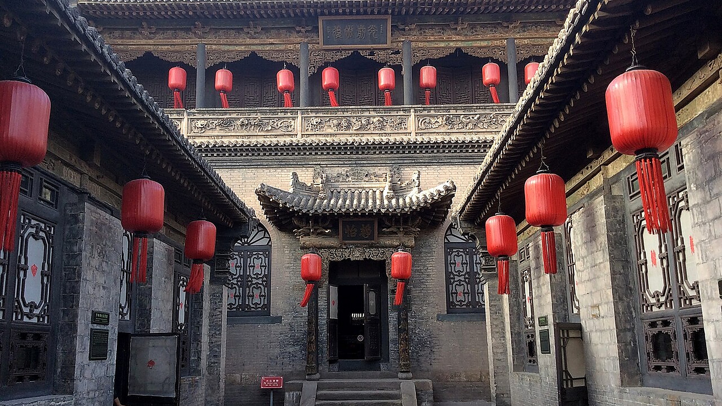Qiao Family Compound (乔家大院) — a 1751 merchant courtyard estate 30 km north of Pingyao, the filming location of the 1991 film Raise the Red Lantern, with 6 large courtyards and 20 small ones.