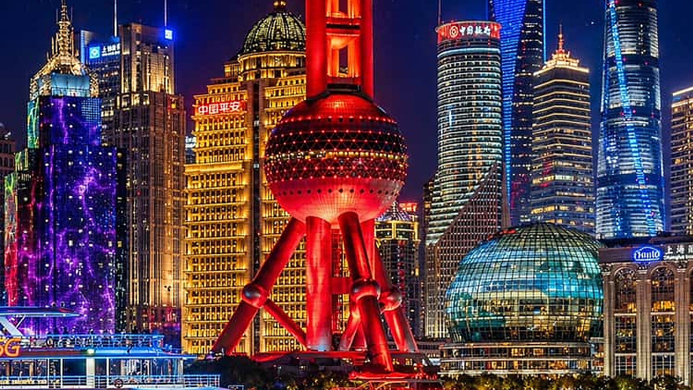 The Bund at night — Shanghai's iconic skyline with the Tower visible.