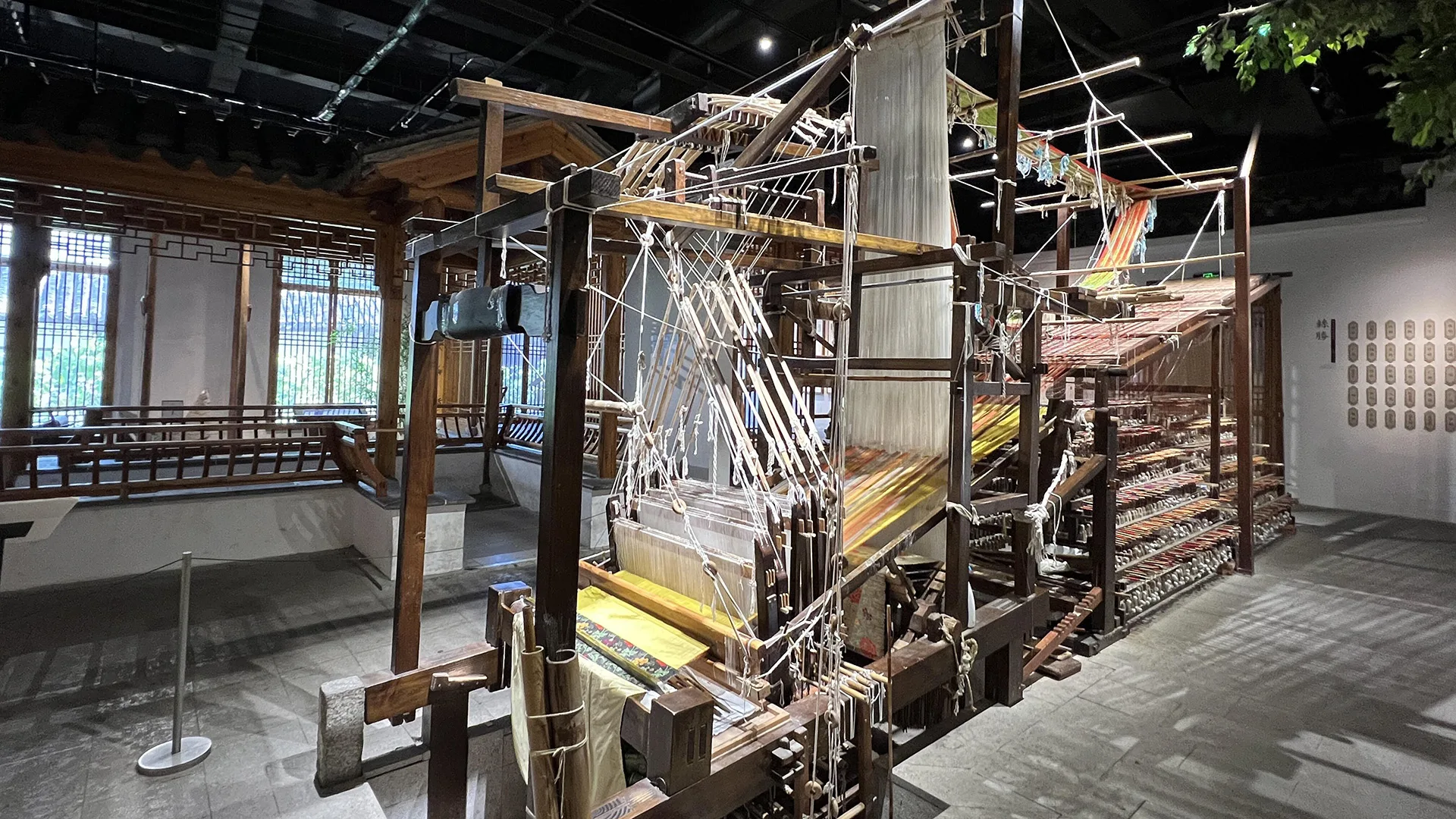 Suzhou Silk Museum — traditional wooden silk looms from the city's 5,000-year silk-making tradition.