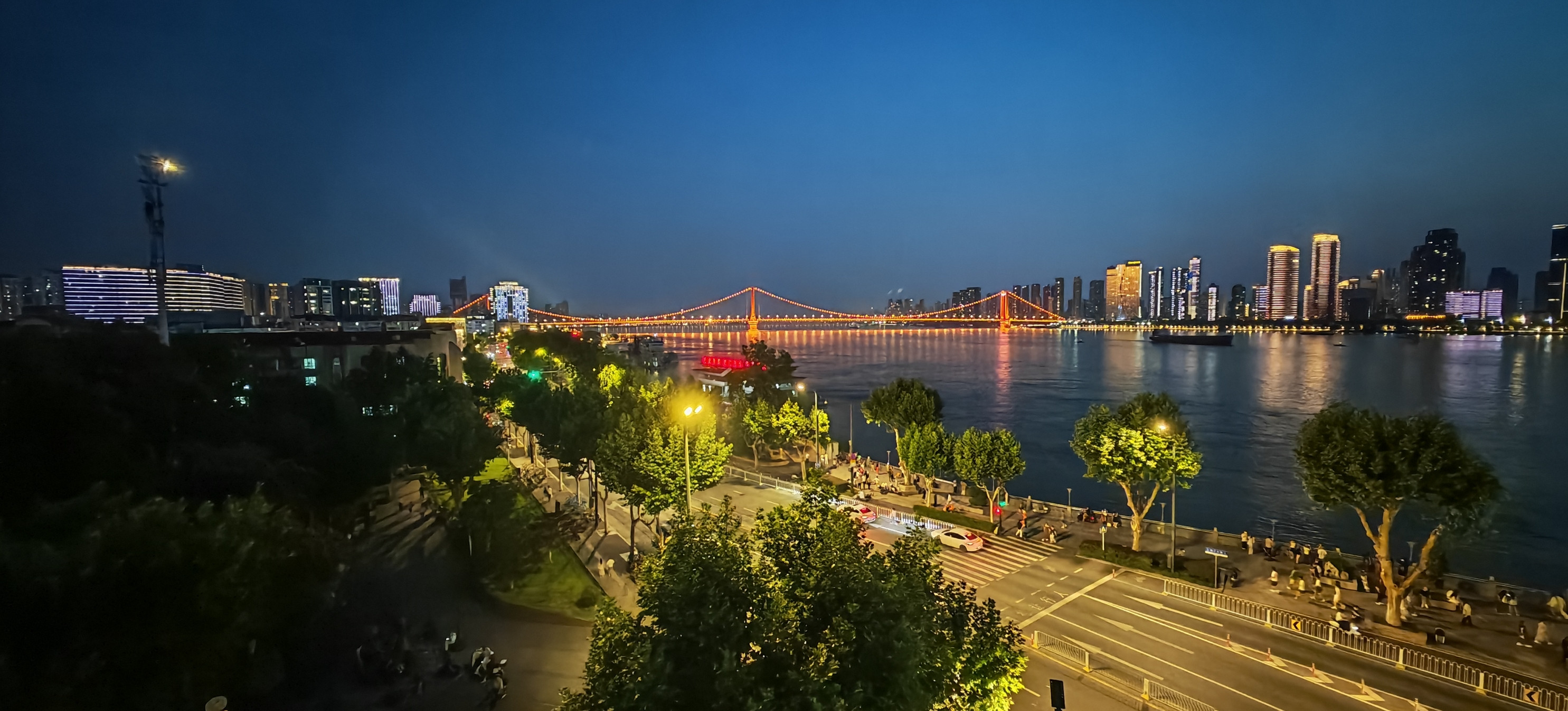 Wuhan Yangtze River at night with the Yingwuzhou Yangtze River Bridge lit red and the city skyline glowing on both banks