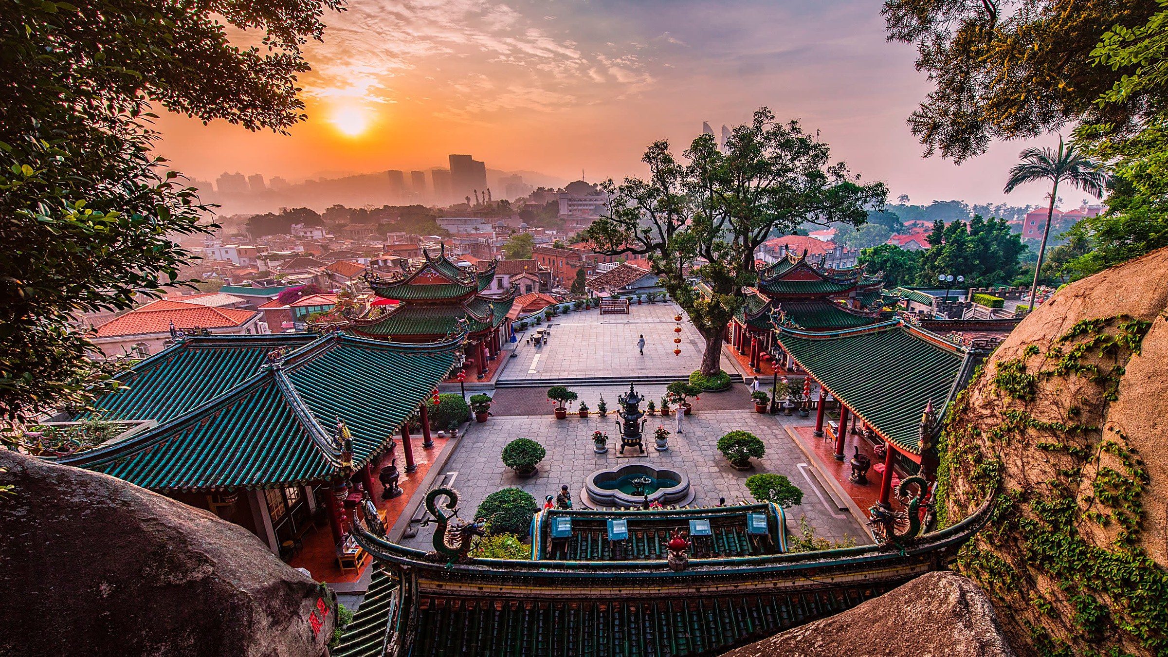 Xiamen city with red-tiled colonial-era rooftops at sunset