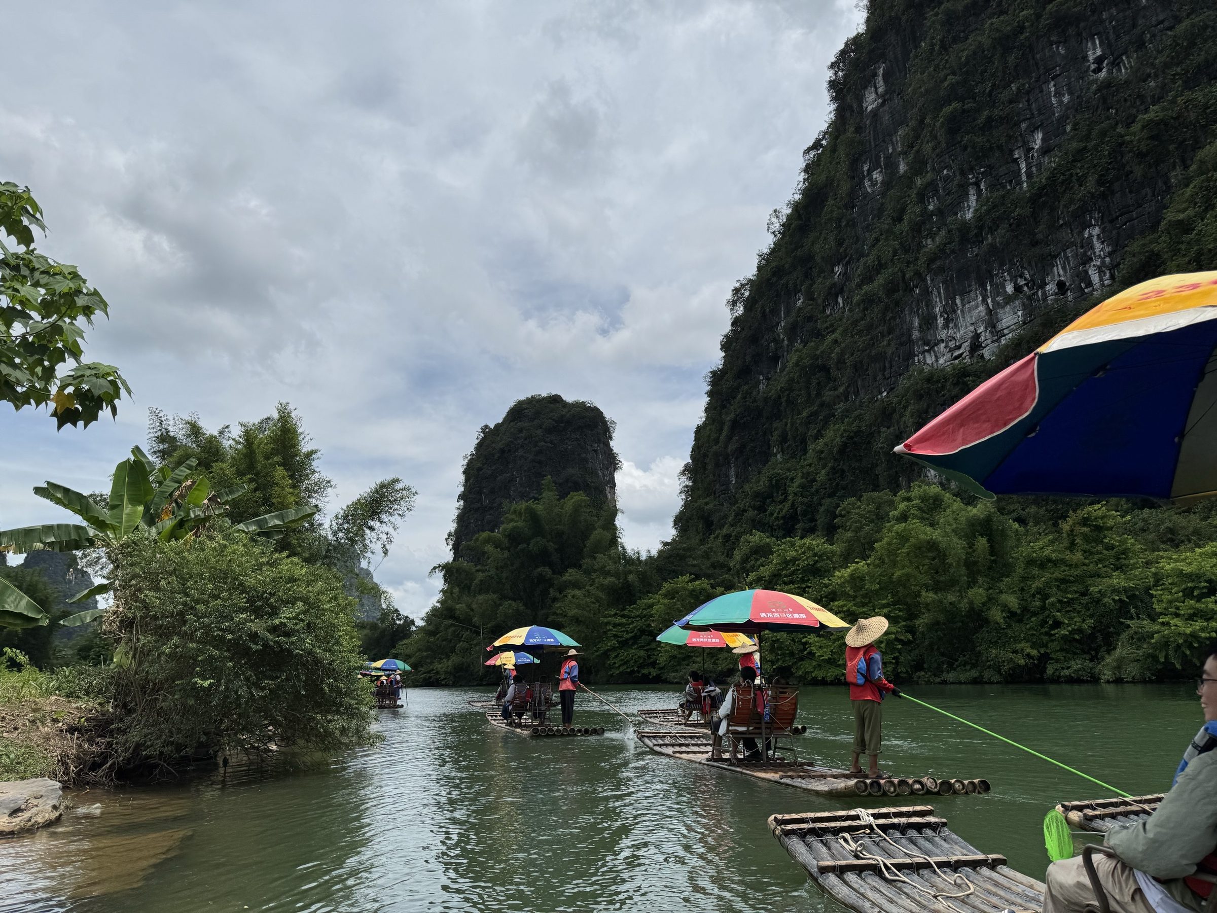 Yulong River bamboo rafting (遇龙河) — a 2-hour bamboo raft ride down the smaller and more intimate Yulong River, with 8 traditional weirs and karst-peak views.