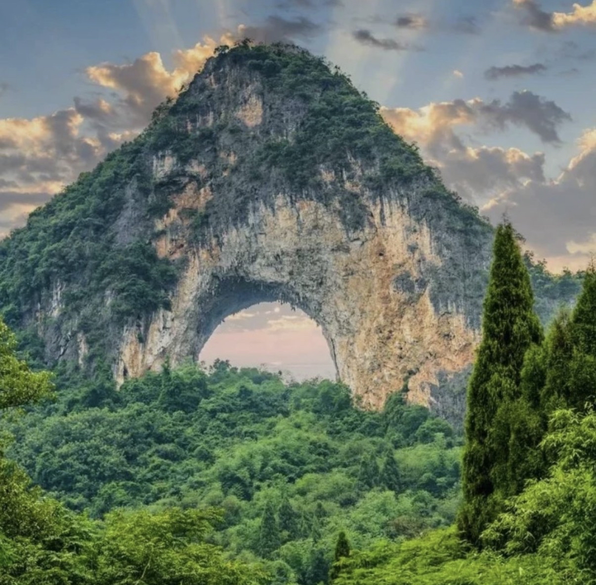 Moon Hill (月亮山) — a 380m karst peak with a natural full-circle arch, climbed via 800 steps for a panoramic view of the Yangshuo countryside.