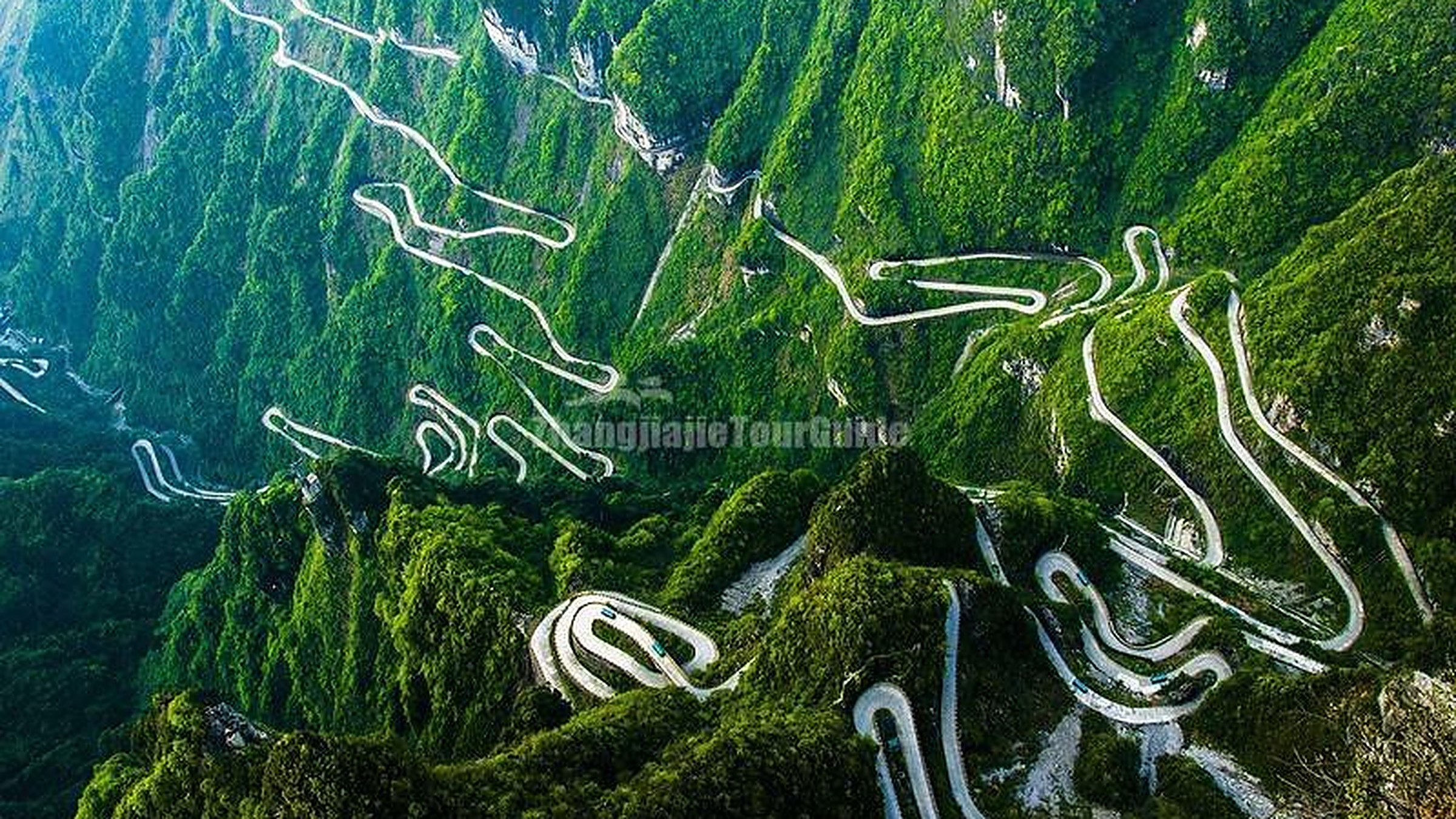 Tianmen Mountain (天门山) — the "Heaven's Gate" mountain famous for the 131.5m natural arch hole, the 99-bend mountain road, and the world's longest passenger cable car (7,455m).