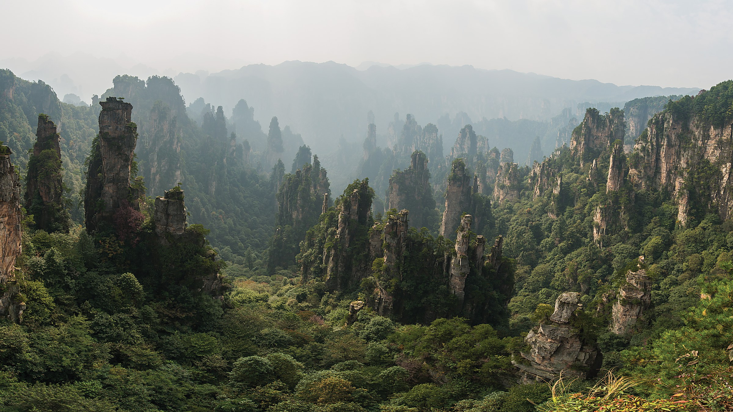 Zhangjiajie Grand Canyon (张家界大峡谷) — a glass-bottom bridge canyon between two cliff walls (the world's highest glass bridge at 300m), waterfalls, and a 20-km mountain river.