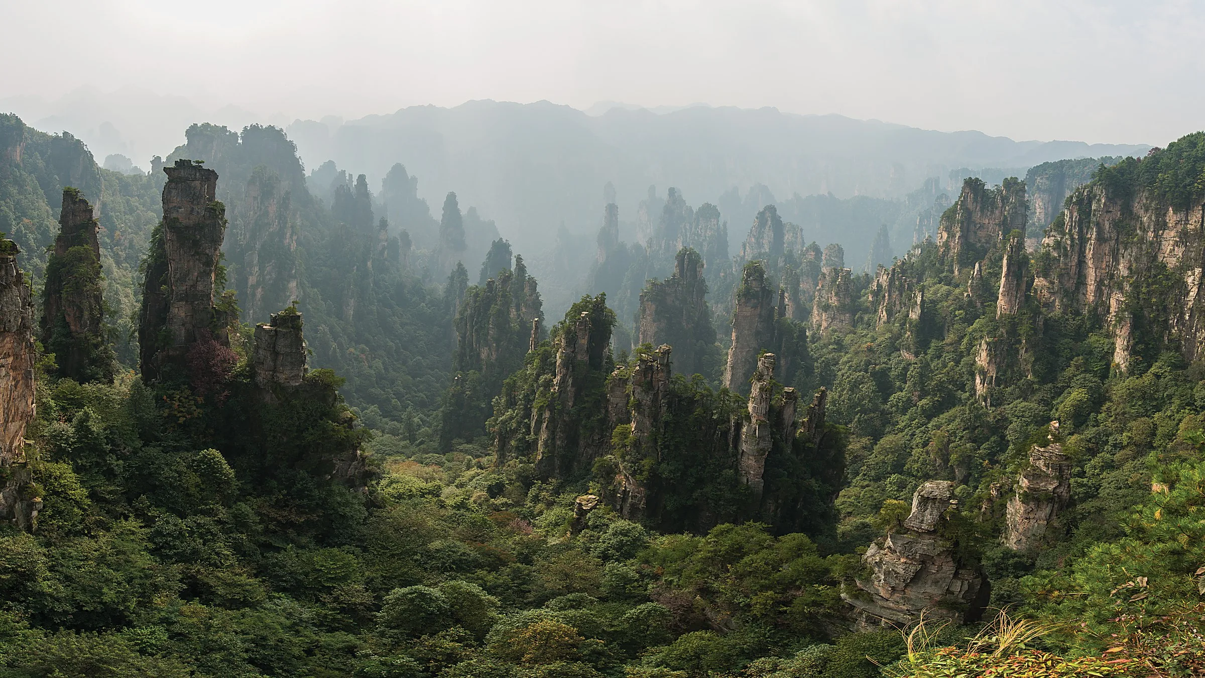 Zhangjiajie Grand Canyon (张家界大峡谷) — a glass-bottom bridge canyon between two cliff walls (the world's highest glass bridge at 300m), waterfalls, and a 20-km mountain river.