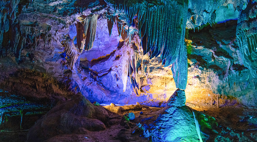 Yellow Dragon Cave (黄龙洞) — one of China's largest karst caves, 7.6 km long with a 50,000 m² main chamber, lit stalactites, stalagmites, and underground rivers.