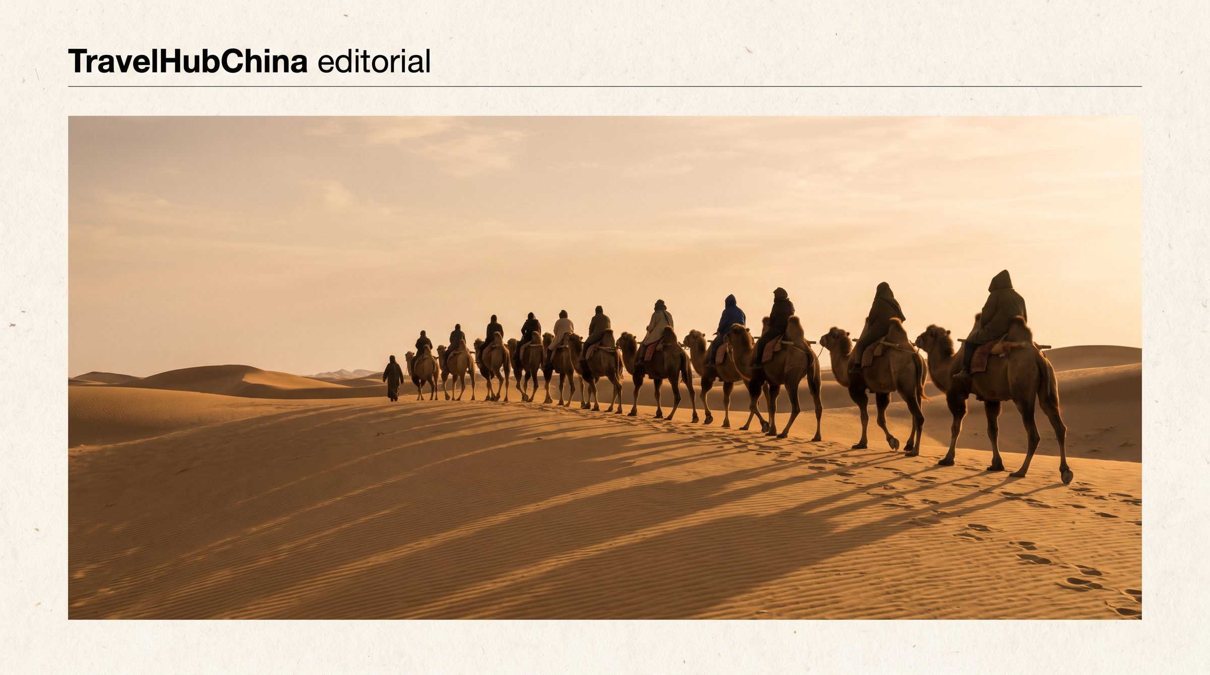 A camel caravan at the base of the Singing Sand Dunes at Dunhuang, with the Mingsha Shan dunes rising in the background under late afternoon light