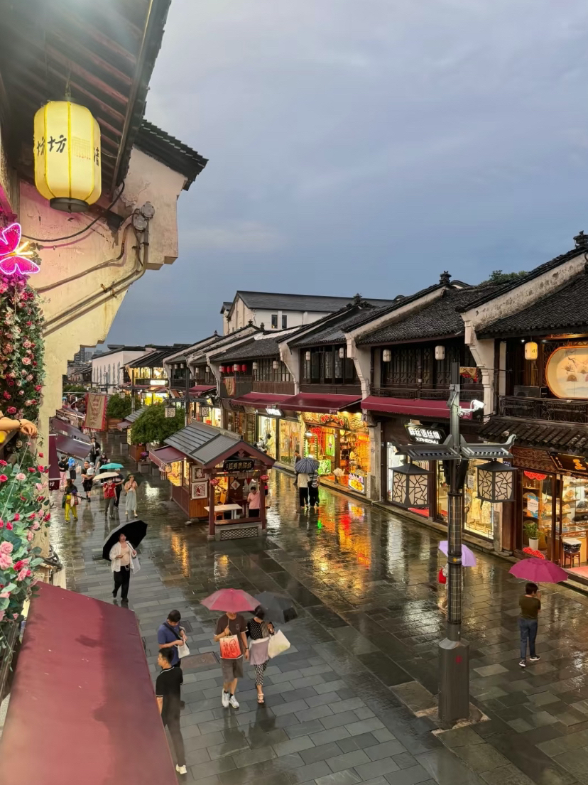 Hefang Ancient Street at night — red lanterns and calligraphy streamers.