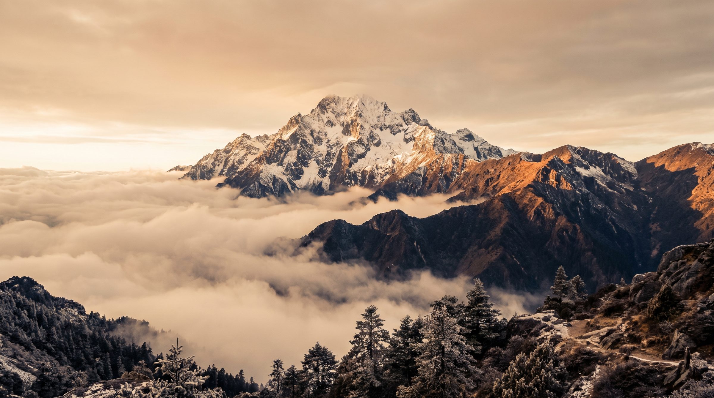Jade Dragon Snow Mountain in Yunnan at sunrise, snow-capped peak rising above low clouds