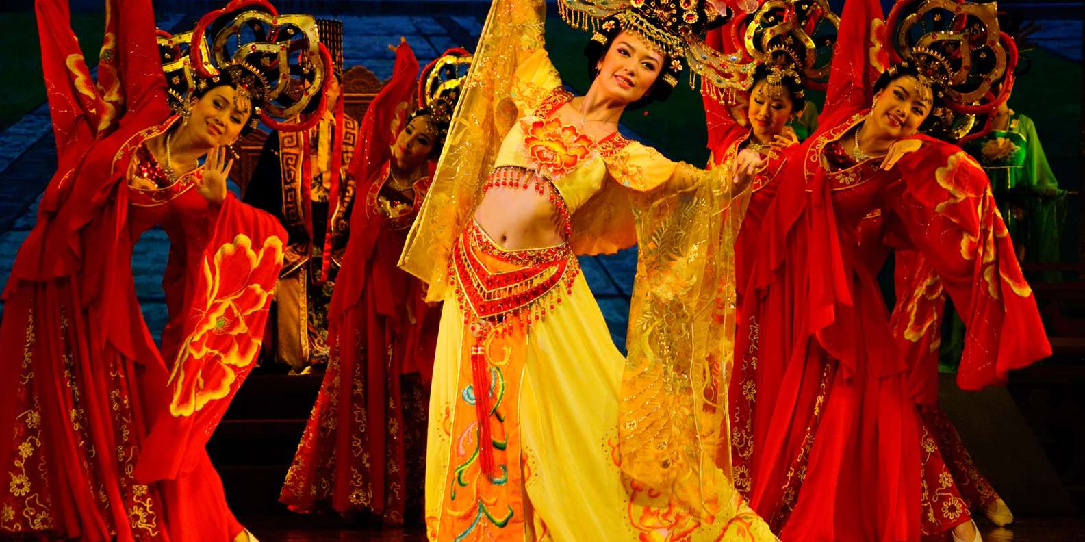 Tang Dynasty show dancers in red and gold Tang-era silk costumes on stage at Tang Paradise, Xi'an